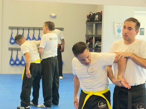 Real Krav Maga Academy students and instructors training together during a larger group session.